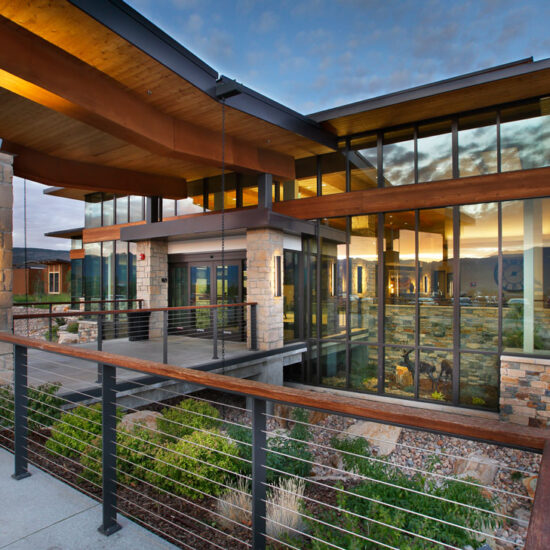 Outside of a Utah Skilled Nursing Facility -Healthcare Architecture that reflects the nature around it. Sunset reflecting in all glass front of building. Designed by TSA Architects. - senior living design firm.