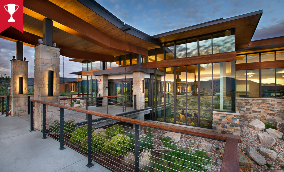 Outside of a Utah Skilled Nursing Facility -Healthcare Architecture that reflects the nature around it. Sunset reflecting in all glass front of building. Designed by TSA Architects. - senior living design firm.
