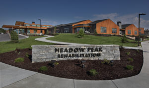 Front view of Meadow Peak Rehabilitation showing sign in the front and building in the back area.